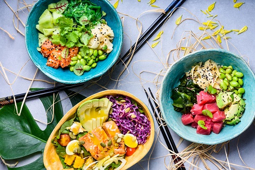 Hawaiian Ahi poke bowl, tuna and salmon with seaweed and edamame. Raw organic. Top view.